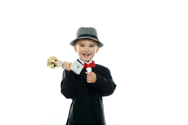 Lycklig pojke i svart kostym håller pris cup — Stockfoto