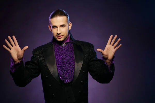 Young handsome brunette magician in stage costume — Stock Photo, Image