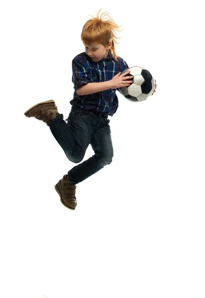 Little boy with soccer ball jumping — Stock Photo, Image