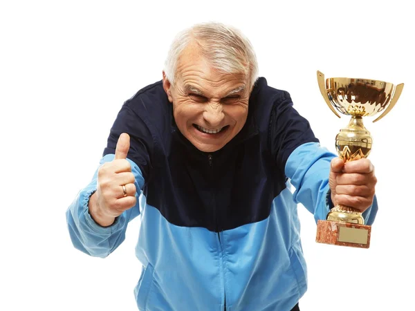 Senior man in opleiding pak met een prijs-kop — Stockfoto