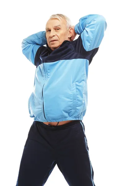 Senior man in training suit doing warm-up stretching exercises — Stock Photo, Image