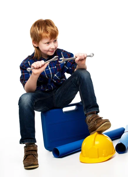 Funny little mechanic boy with wrench tools sitting on toolbox — Stock Photo, Image