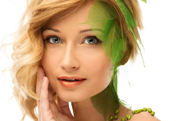 Beautiful young woman in conceptual spring costume touching her face Stock Image