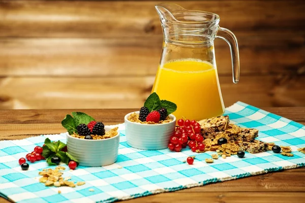 Healthy breakfast with fresh orange juice on tablecloth in wooden rural interior — Stock Photo, Image