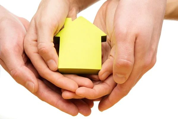Man and woman hands holding conceptual paper house — Stock Photo, Image