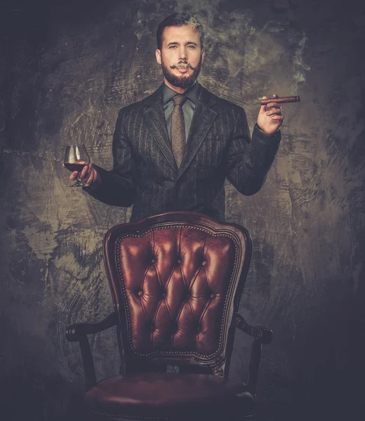 Handsome well-dressed with glass of beverage and cigar — Stock Photo, Image