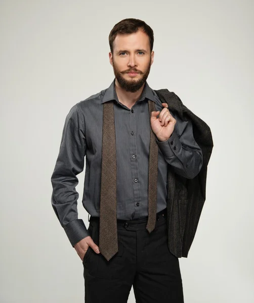 Handsome man with jacket over his shoulder — Stock Photo, Image