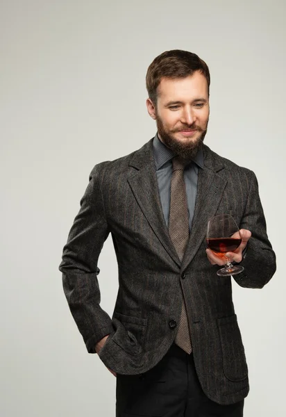 Bardak içecek ceketli yakışıklı iyi giyimli adam — Stok fotoğraf