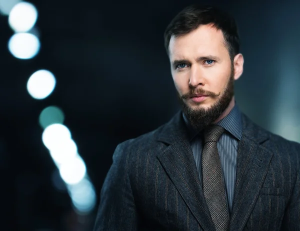 Handsome well-dressed man in jacket with beard and mustache — Stock Photo, Image