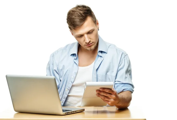 Concentrated stylish young man behind laptop isolated on white — Stock Photo, Image