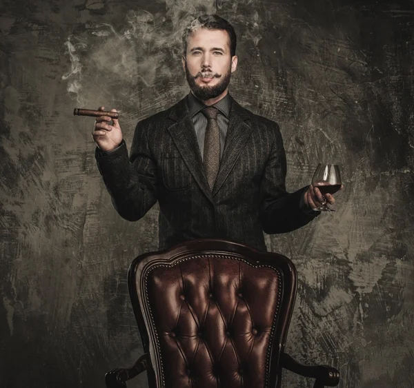 Handsome well-dressed with glass of beverage and cigar — Stock Photo, Image