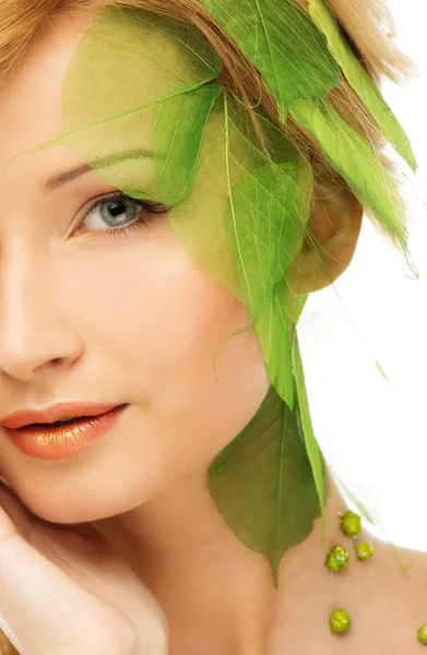 Beautiful young woman in conceptual spring costume touching her face Stock Image