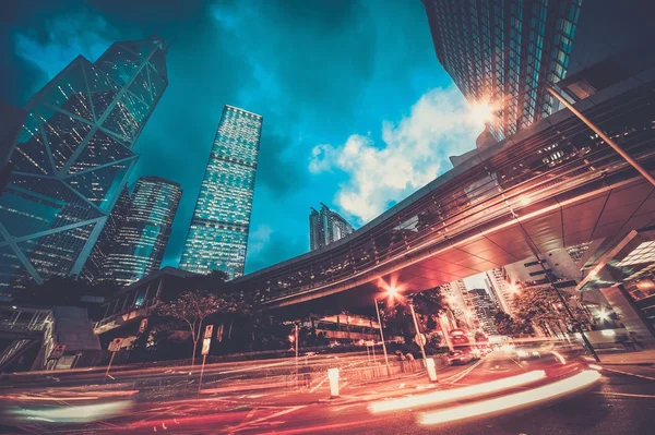 Fast moving cars at night in modern city — Stock Photo, Image