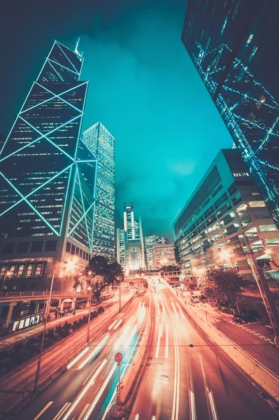 Fast moving cars at night in modern city — Stock Photo, Image