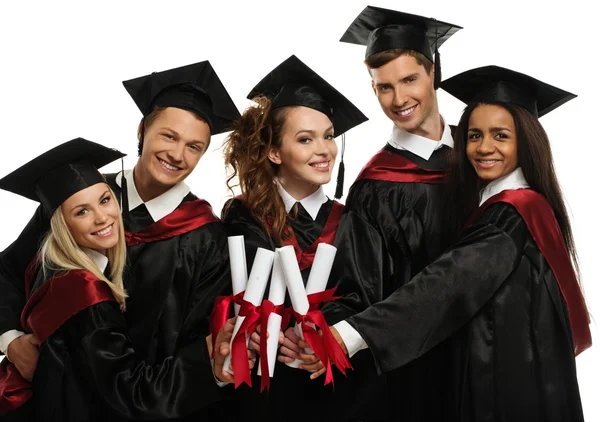 Grupo étnico multi de estudantes jovens graduados isolados em branco — Fotografia de Stock