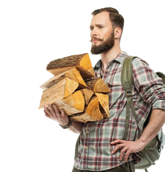 Handsome traveler with backpack and logs for bonfire — Stock Photo, Image