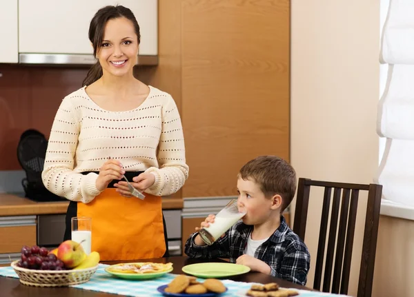 Joven madre feliz y su hijo comiendo un desayuno saludable —  Fotos de Stock