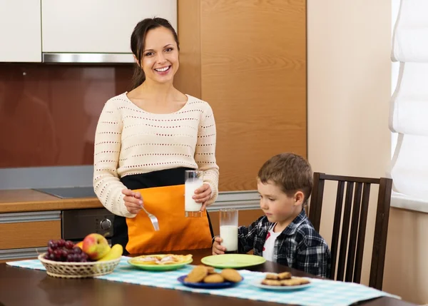 Joven madre feliz y su hijo comiendo un desayuno saludable —  Fotos de Stock