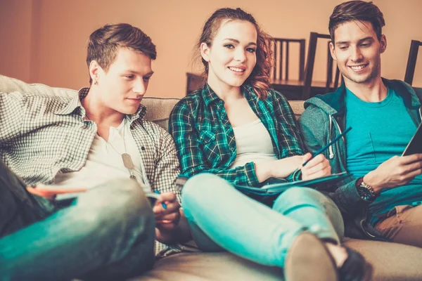 Three young students preparing for exams in apartment interior — Stock Photo, Image