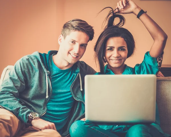 Junges multiethnisches Studentenpaar bereitet sich im heimischen Interieur auf Prüfungen vor — Stockfoto