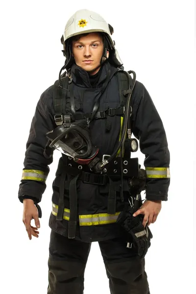 Jovem bombeiro usando capacete isolado em branco — Fotografia de Stock