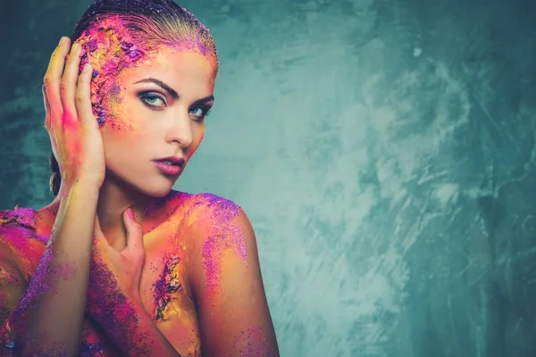 Beautiful young woman with conceptual colourful body art — Stock Photo, Image