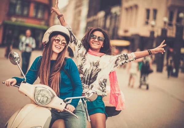 Multi ethnic girls on a scooter in european city — Stock Photo, Image