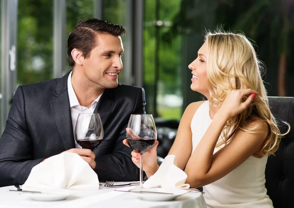Cheerful couple in a restaurant with glasses of red wine Royalty Free Stock Photos