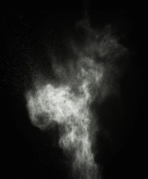 White powder exploding isolated on black — Stock Photo, Image