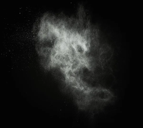 White powder exploding isolated on black — Stock Photo, Image