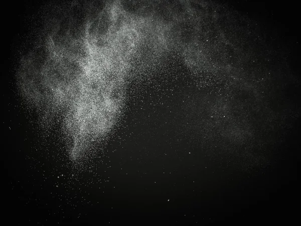 White powder exploding isolated on black — Stock Photo, Image