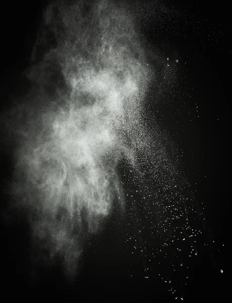 White powder exploding isolated on black — Stock Photo, Image