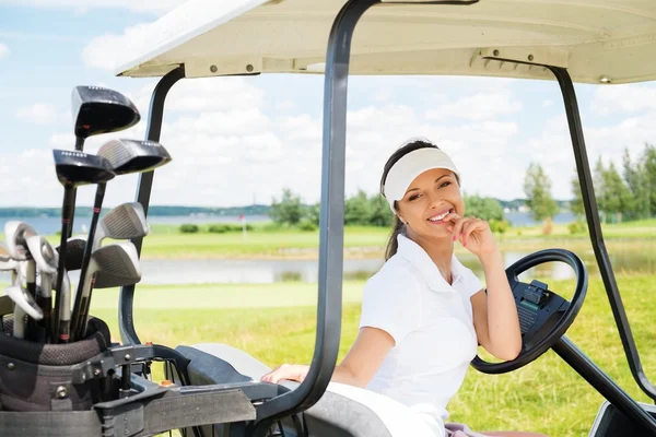 Mujer conduciendo carrito de golf — Foto de Stock