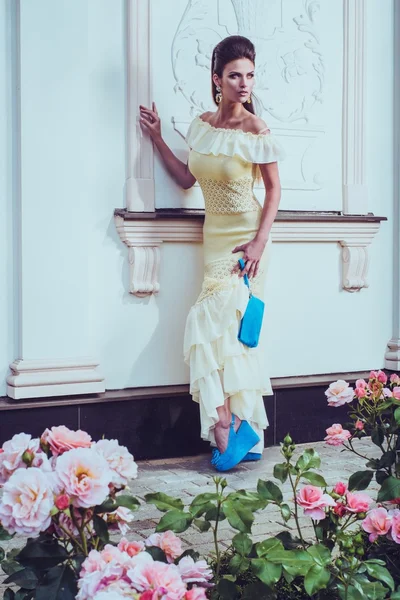Vrouw in jurk in de buurt van luxe gebouw — Stockfoto