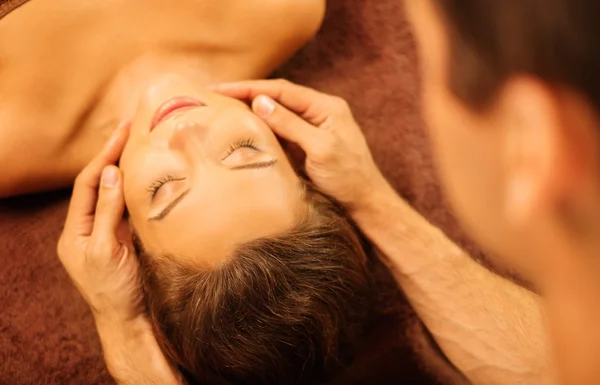 Young woman having face massage in a spa salon — Stock Photo, Image