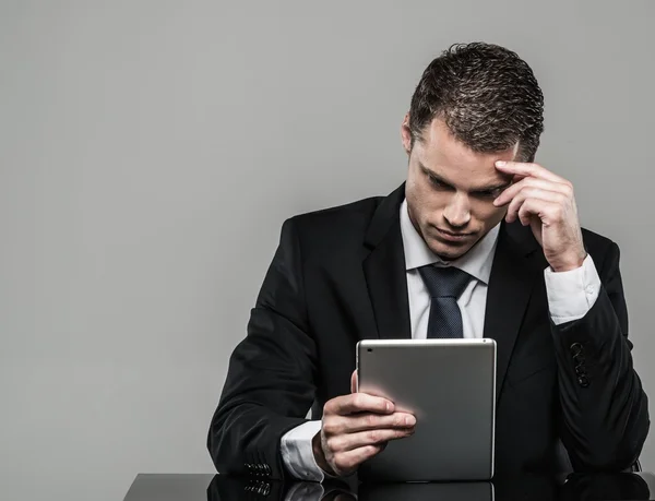 Well-dressed man in black suit with tablet pc — Stock Photo, Image