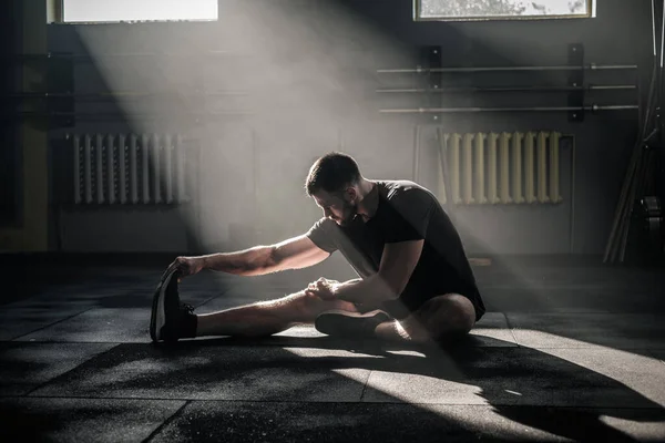 Спортсмен розтягує ноги  . — стокове фото
