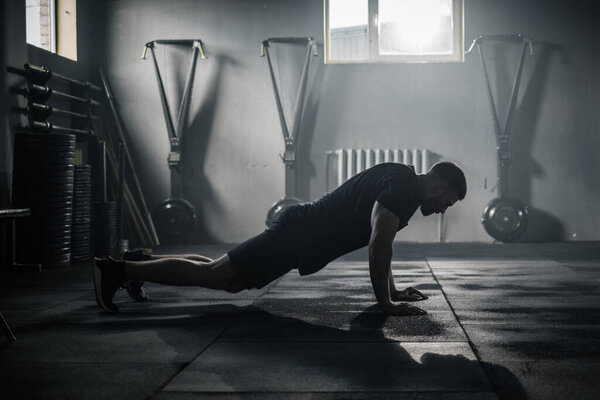 Sportsman Do Exercises at Big Dark Gym . Stock Photo