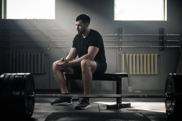 Handsome Man Sit on Bench at Gym . Stock Picture