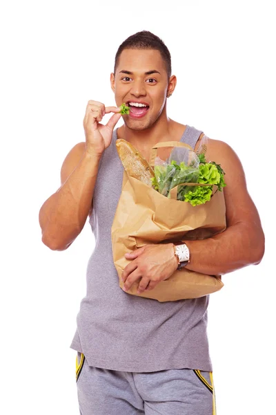 Portrait of handsome man eating salad in studio — Stock Photo, Image