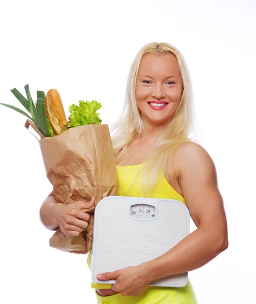 Portrait of smiling woman poing in studio with food — Stock Photo, Image