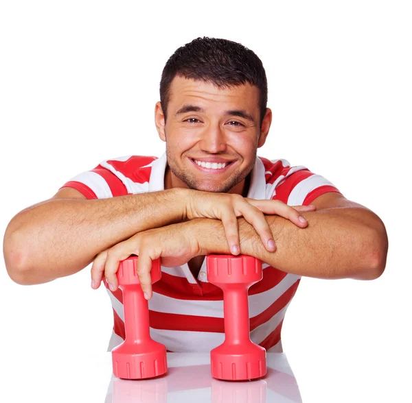 Portrait of smiling man posing in studio with dumbbells — Stock Photo, Image