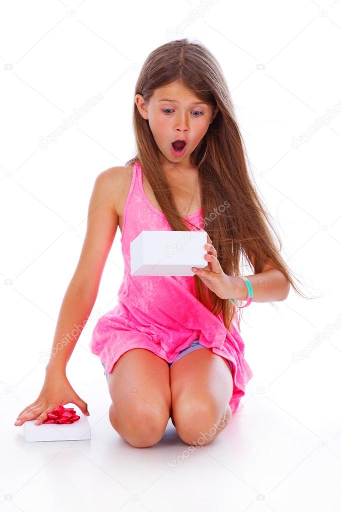Portrait of beautiful girl posing in studio with white box