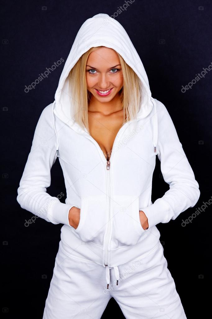 Portrait of smiling yoga trainer posing on black background