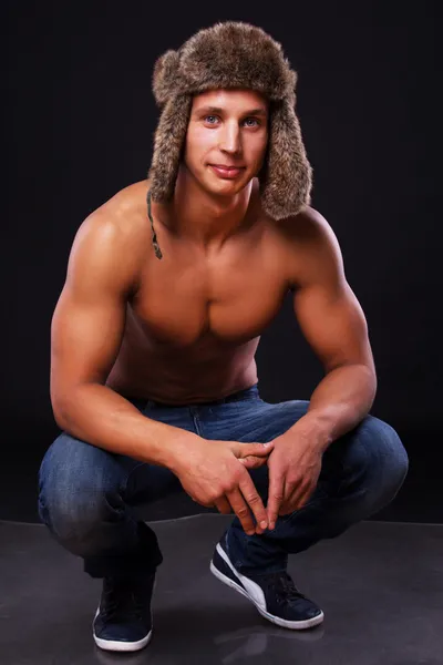 A young man in a fur hat — Stock Photo, Image