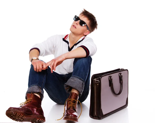 Portrait of sleazy young man posing on white background with bag — Stock Photo, Image
