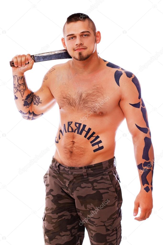 A topless male with a knife