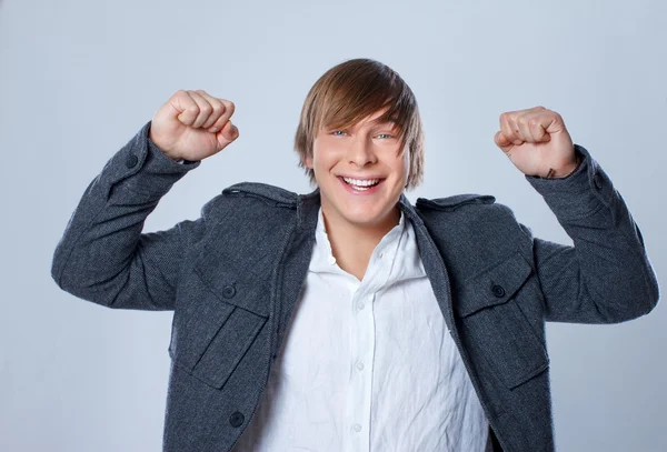 Portrait of handsome man posing on grey background — Stock Photo, Image