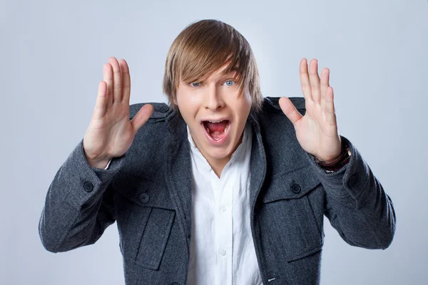 Portrait of handsome man posing on grey background — Stock Photo, Image