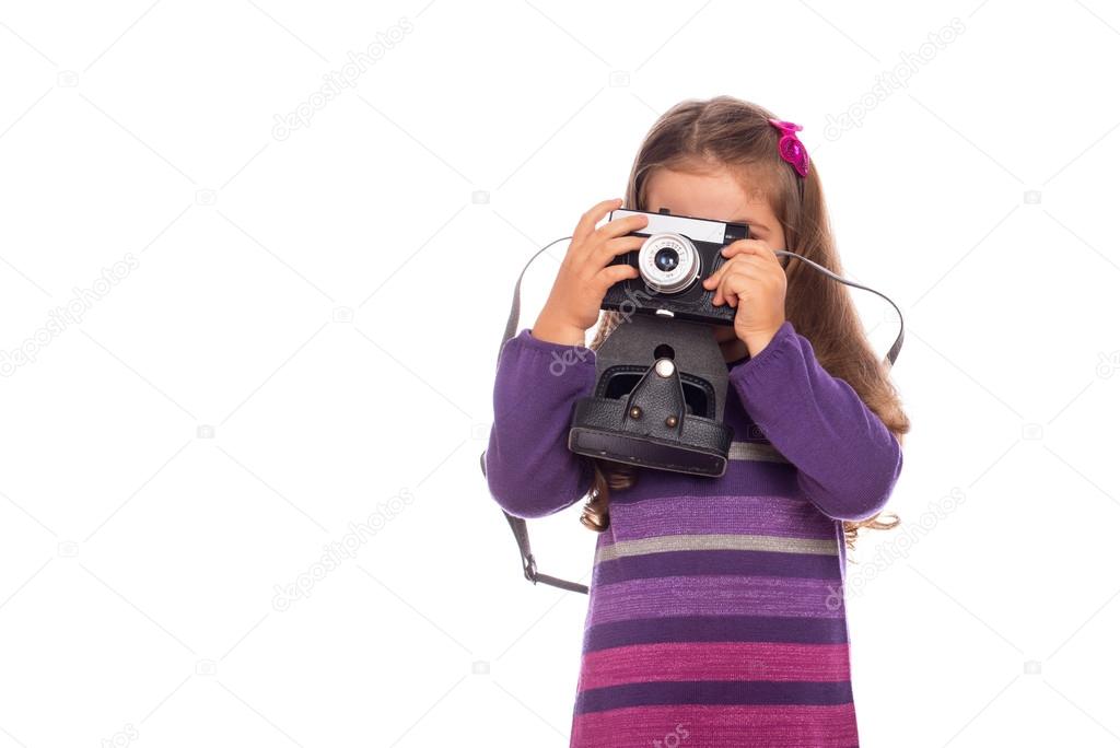 A kid is fooling around with a camera